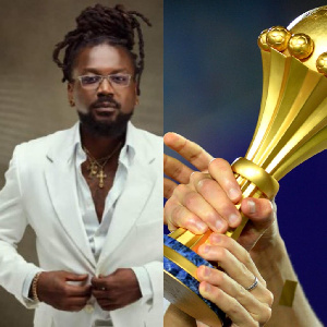 Ghanaian musician, Samini (L) AFCON trophy (R)