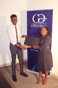 Oreoluwa Ogundipe receiving the award from Mrs. Harriet Yartey Managing Director of CWG Ghana