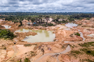 Aerial view of deforested area of Amazon rainforest caused by illegal mining activities in Brazil