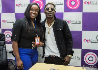 Shatta Wale poses for a photo with Citi Fm's Jessica Opare Saforo