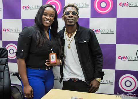 Shatta Wale poses for a photo with Citi Fm's Jessica Opare Saforo