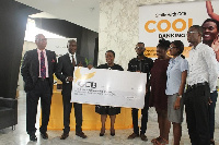 Officials handing over the GHC150,000 cheque to beneficiaries