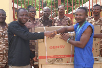 Ambassador Extraordinaire of Prisons, Ibrahim Oppong Kwarteng presenting the machine to Ishmael