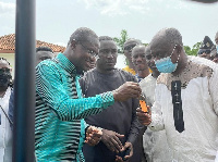 Ashanti Regional Minister, Simon Osei-Mensah receiving the keys to the trucks