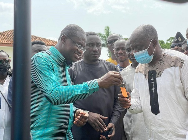 Ashanti Regional Minister, Simon Osei-Mensah receiving the keys to the trucks