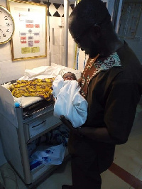 Steve Atubiga with his newly born baby