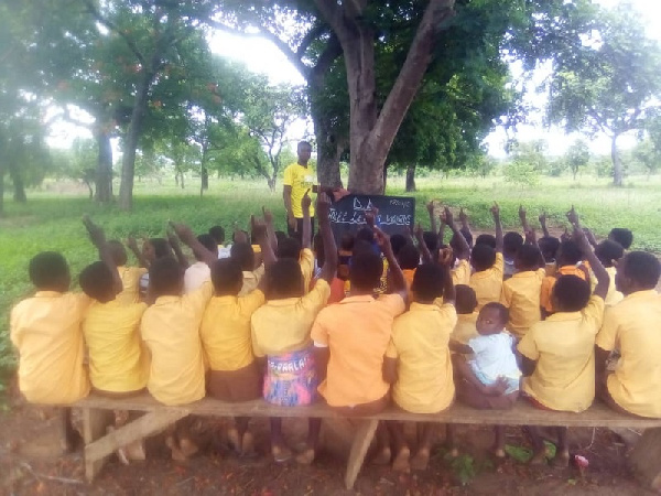 The pupils seated under the trees