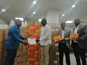 Mr Agyemang Manu (left) receiving the items from Mr Tobbin