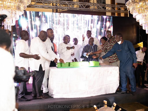 Kyei-Mensah-Bonsu (in smock) helped to cut the E-LEVY cake | Photo credit: FOTOKONCEPTGH