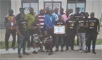 Black Bombers in a group photograph with the Ghana Olympic Committee members