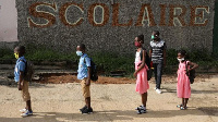 Children queue to wash their hands in a school in Ivory Coast