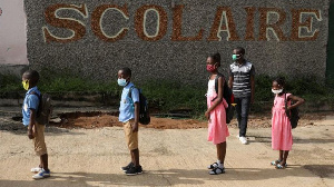 Children queue to wash their hands in a school in Ivory Coast