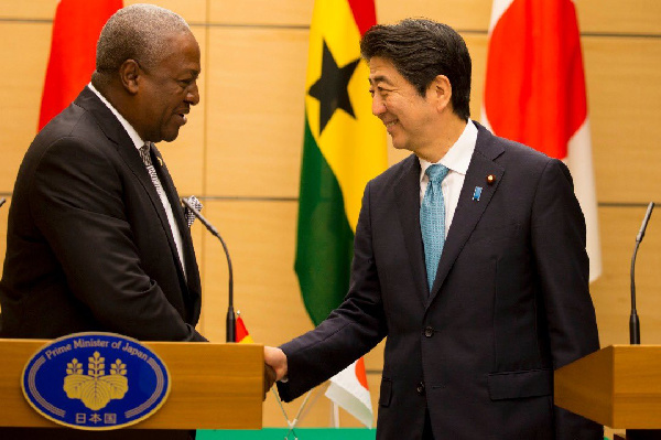 John Mahama shares a handshake with the late former PM, Abe Shinzo