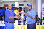Appiah(left) representing the winner's trophy to Antwi