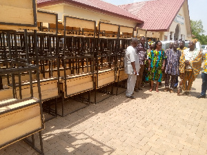 Agnes Anamoo, the Nabdam DCE, presenting the furniture to the Education Directorate