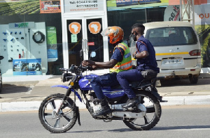 Police officers on motor-bike flout social distance directive. Photo Vincent Dzatse