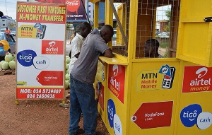 A customer making deposit at a mobile money agent shop