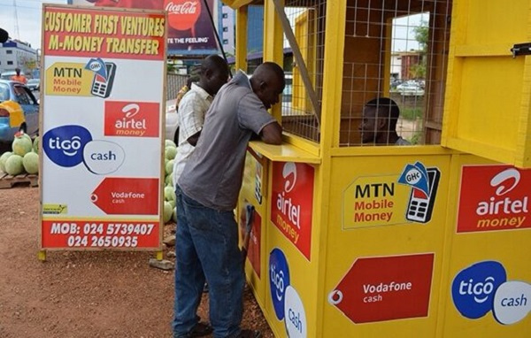 A customer making deposit at a mobile money agent shop