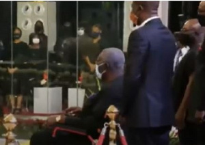 Former President John Agyekum Kufuor being assisted to pay his last respect to Rawlings