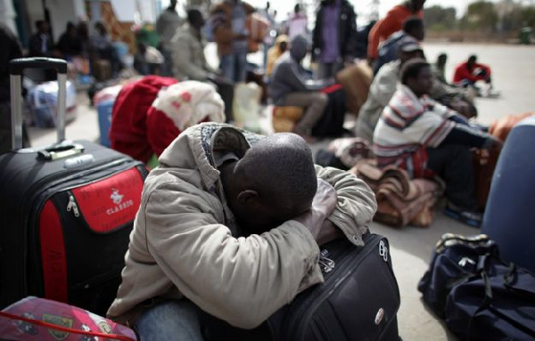 Deportees sitting on their luggage