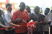 Kwame Osafo-Amoah, Airtel Zonal Business Manager (middle) being aided to commission the facility