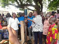 Hon Kojo Asemanyi presenting the over 13,500 litres of premix fuel to the fisherfolks