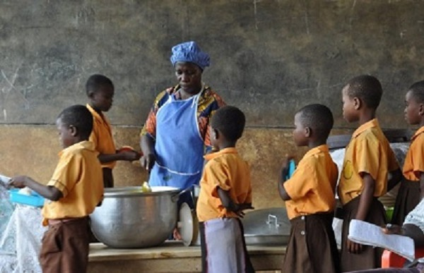 Students receiving food from a school feeding programme caterer