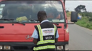 An NSRA officer checking the credentials of a driver