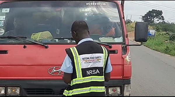 An NSRA officer checking the credentials of a driver