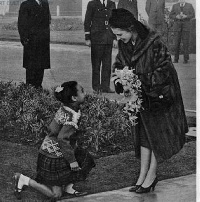 Pearl Acquaye is seen bending the knee after she presents the bouquet to the monarch