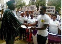 Isaac Nyampong (Right), the Programme Officer of ARHR, presenting the manifesto to the Minister