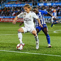 Mubarak Wakaso battles Modric for the ball