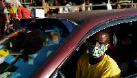 A taxi driver wearing a nose mask