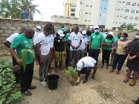 A photograph of the Attorney General planting a tree