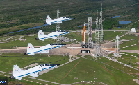 T-38 planes, a fixture of astronaut training at Nasa, fly over the SLS on launch pad 39B at Kennedy