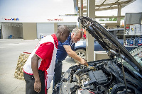 The Retail Network Manager, Mr. Thierry Cauveau happily serves a customer.