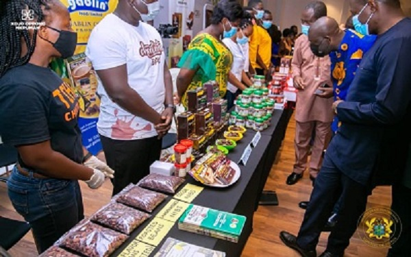 COCOBOD CEO and Information Minister examining some exhibits of cocoa products