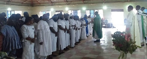 Rev Fr Awafo leading the family and sympathisers in a prayer