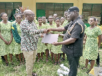 COP Francis Ebenezer Doku (right) presents the laptops to Philip Narh Odonkor (right)