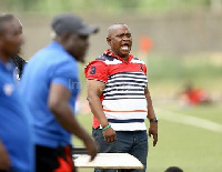 Black Satellites coach, Jimmy Cobblah (red striped lacoste)