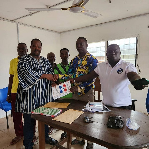 Ishmael Evonla Whajah (in smock) presenting his nomination forms to NPP officials in Jomoro