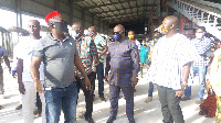 Mr. Boateng,red cap, taking the dignitaries around the facility