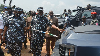 Govnor Uzodinma wey hold stick as im dey inspect some police equipment