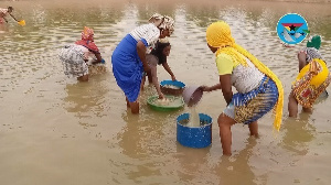 Women in the community fetching water from the dam for domestic use