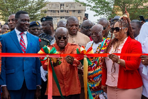 Akuf-Addo flanked by Adwoa Safo and Education Minister as he cuts tape for model school