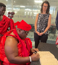 Nii Ayi-Bonte II signing the book of condolence