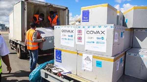 Workers load boxes of Oxford/AstraZeneca Covid-19 vaccines, part of the the Covax programme