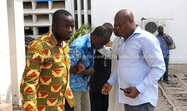 Dr. Obengfo [2nd from left] being assisted to walk at the court premises