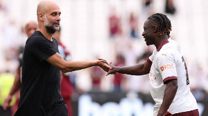 Manchester City manager, Pep Guardiola and Jeremy Doku