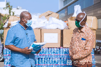 Former President of Ghana, John Dramani Mahama (left) presenting the items